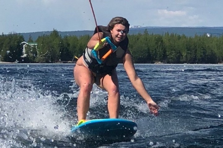 a person riding a surf board on a body of water